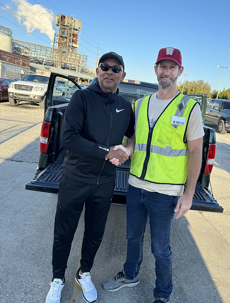 Brendon Barber, executive director of Helping Hands of Georgetown with International Paper Georgetown Mill's Communications Manager Joshua Fleming.